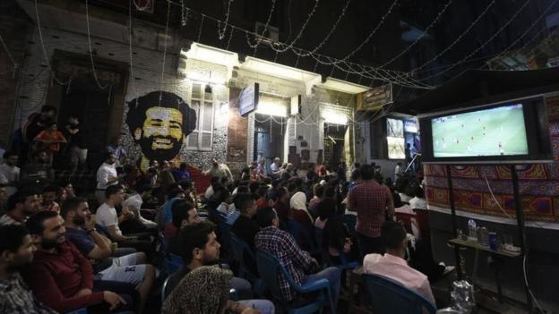 Egyptian fans watch the 2019 UEFA Champions League final on a Cairo street