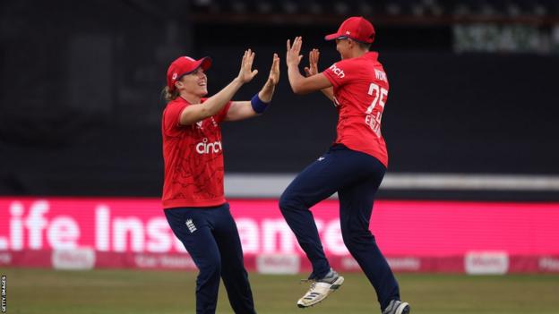 Heather Knight (links) und Issy Wong (rechts) springen und feiern gemeinsam ein Wicket