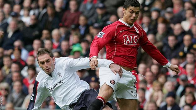 Nicky Hunt and Cristiano Ronaldo challenge for the ball at Old Trafford in August 2003