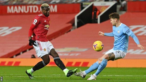 John Stones blocks a shot by Paul Pogba