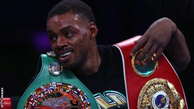 Errol Spence Jr smiles with his IBF and WBO welterweight titles