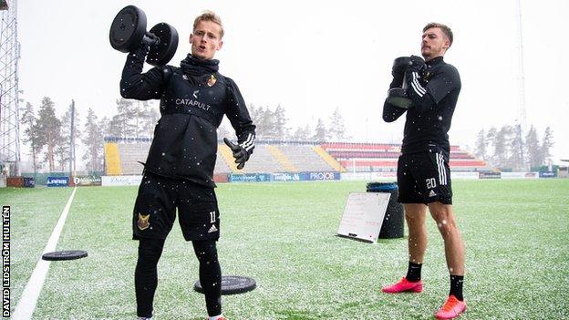 Ostersund players go through a weights session on their pitch