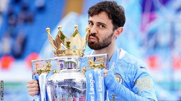 Manchester City midfielder Bernardo Silva with the Premier League trophy after his side won the title in 2020-21
