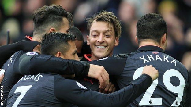 Mesut Ozil (centre) celebrates with team-mates