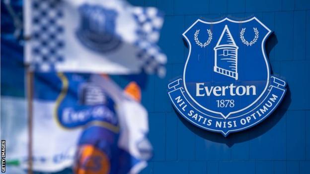 Everton badge with flags outside stadium