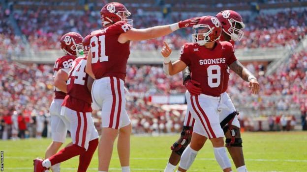 Quarterback Dillon Gabriel is congratulated by his Oklahoma team-mates