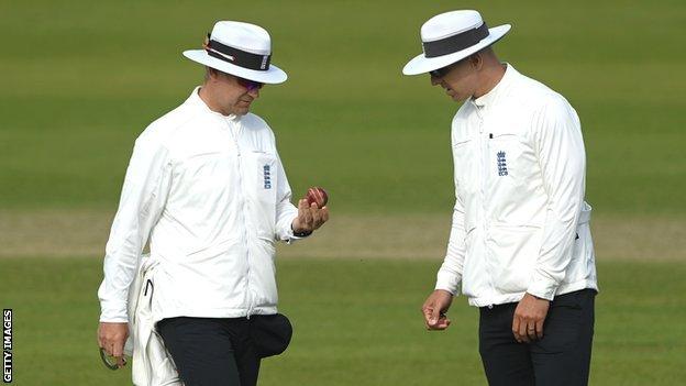 Umpires inspect the ball during Durham's County Championship match against Glamorgan