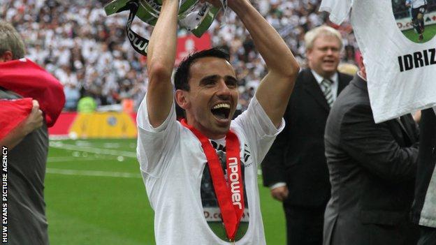 Leon Britton celebrates promotion to the Premier League after winning the play-off final in 2011