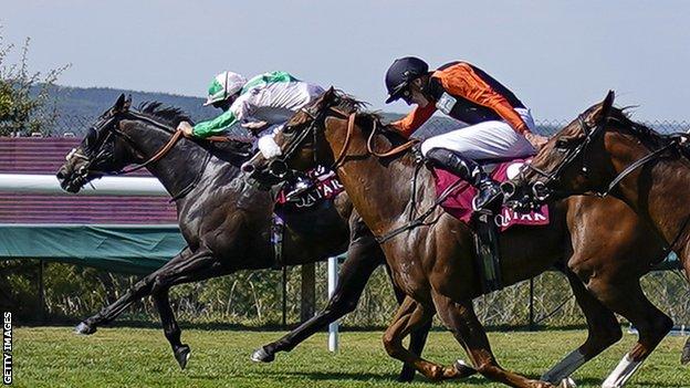 Khaadem and Raasel ride towards the finish