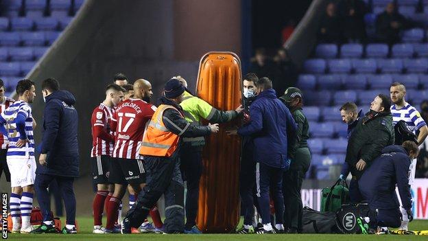 Sheffield United midfielder John Fleck is treated after collapsing during Reading v Sheffield United
