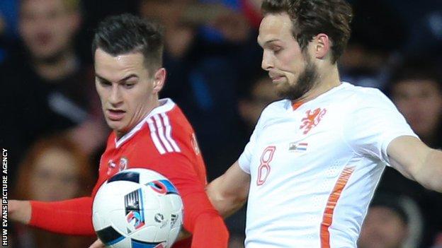 Tom Lawrence (left) takes on Daley Blind during Wales' 3-2 friendly loss to Netherlands in November 2015