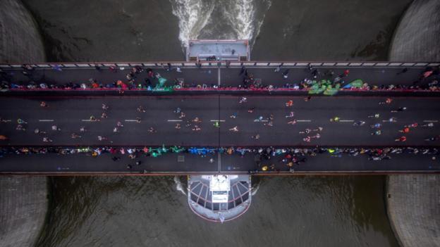 3 October: Runners cross Tower Bridge during the London Marathon, which attracted about 80,000 participants