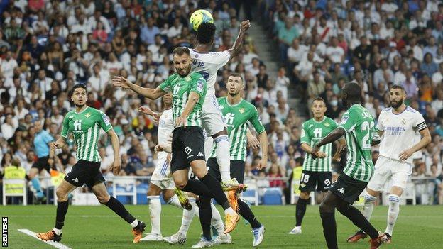 Real Madrid's Vinicius Junior challenges for the ball against Real Betis