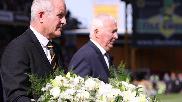 Steve Bull and Mike Summerbee lay floral tributes inside the centre circle at Molineux