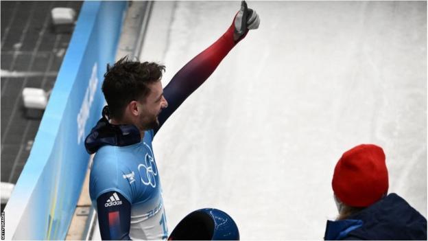 Marcus Wyatt gives a thumbs up after competing in the men's skeleton at the Beijing 2022 Winter Olympics