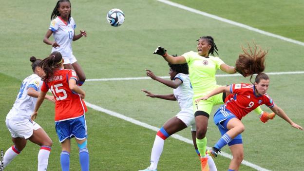 Kerly Theus punches the shot  for Haiti against Chile