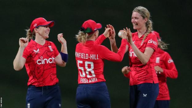 Lauren Bell (right) celebrating a wicket with Heather Knight (left) and Lauren Winfield-Hill (centre)