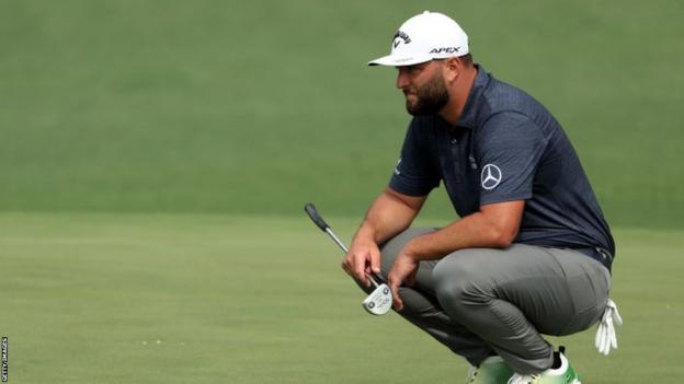 Jon Rahm lines up   a putt during his archetypal  circular  astatine  the 2023 Masters