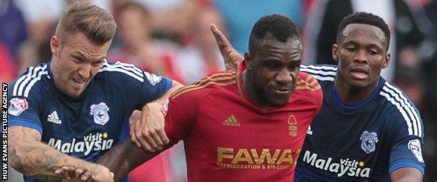 Forest goalscorer Michail Antonio battles past two Cardiff players