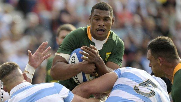 South Africa's Damian Willemse is tackled by Argentina's Marcos Kremer and Tomas Lavanini