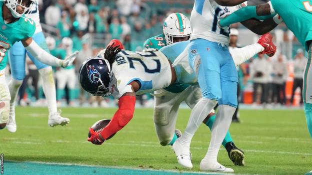 Derrick Henry diving over for a late touchdown to secure an NFL victory for the Tennessee Titans over the Miami Dolphins