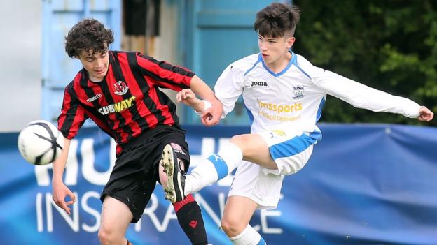 Dean Morgan of Crusaders in action against Newry's Tiernan Hughes during the Under-15 Rosebowl final which the Crues won 3-0