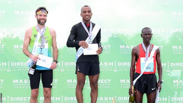 On the Belfast Marathon podium are runner-up Adam Bowden, winner Mohamed Oumaarir and third-placed finisher Bernard Rotich