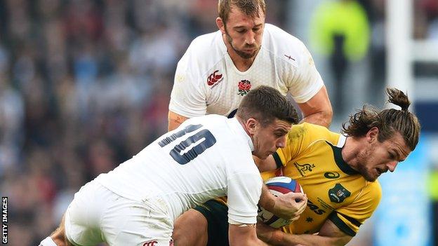 Rob Horne of Australia is tackled by George Ford and Chris Robshaw of England