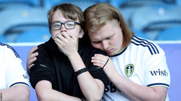 Leeds United fans react after their team is relegated from the Premier League