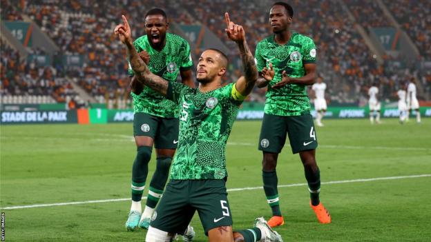 William Troost-Ekong (centre) celebrates scoring a penalty for Nigeria against South Africa at the 2023 Africa Cup of Nations