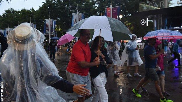 Fans with umbrellas