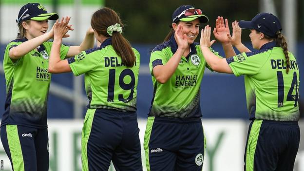 Laura Delany (right) celebrates a wicket with team-mates Arlene Kelly, Georgina Dempsey and Rachel Delaney during a T20 international against Australia at Bready in July