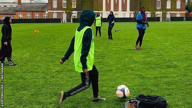 Players of Sisterhood FC training in front of Goldsmith's University