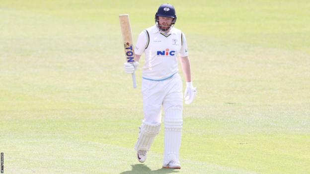 Jonny Bairstow raises his bat aft  reaching 50