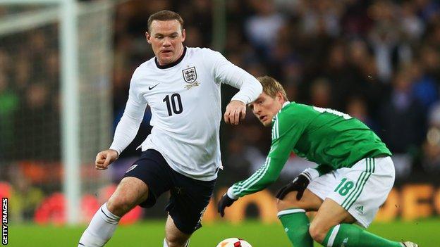 England striker Wayne Rooney (left) and Germany's Toni Kroos