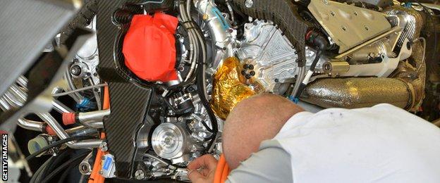 McLaren Mercedes mechanics work on an engine ahead of the Formula One Australian Grand Prix in Melbourne on March 13, 2014
