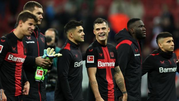 Granit Xhaka jokes with Leverkusen team-mates