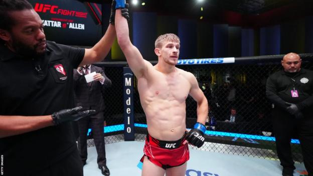 Arnold Allen gets his hand raised by referee Herb Dean after beating Calvin Kattar in October