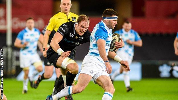 Alun Wyn Jones of Ospreys chases down Fergus McFadden of Leinster