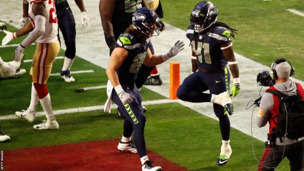 Alex Collins celebrates a touchdown for the Seattle Seahawks