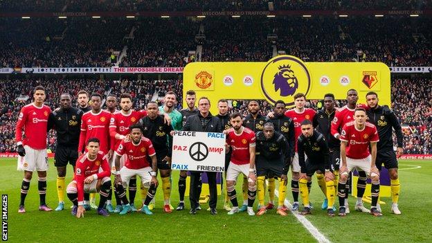Both teams plus managers stood in front of a banner before kick-off, which proclaimed the word ‘Peace’ in numerous languages