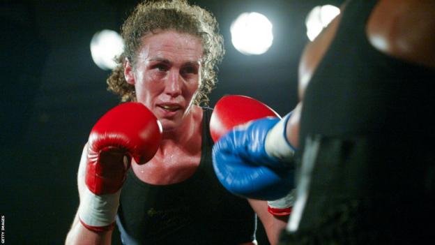 Jane Couch in the ring with her boxing gloves up