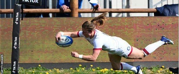 England's Lydia Thompson dives over