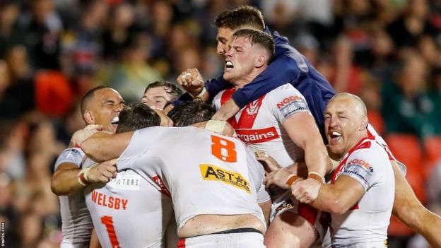St Helens pile on Lewis Dodd after his drop-goal winner in the World Club Challenge against Penrith