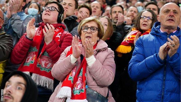 Liverpool fans applaud in the seventh minute of the match against Manchester United in support of Cristiano Ronaldo following the death of his baby boy