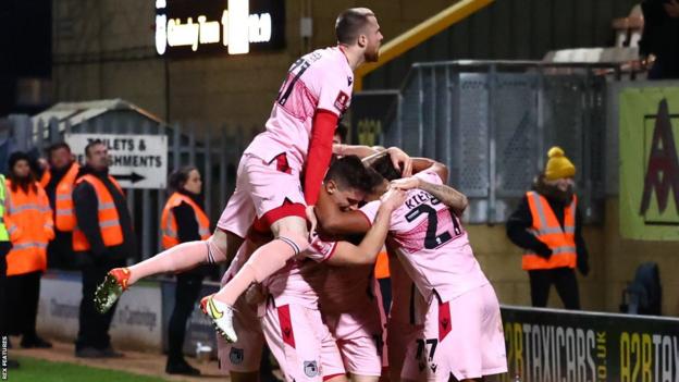 Grimsby Town's players celebrate against Cambridge United