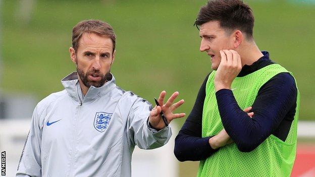 Harry Maguire (right) with England boss Gareth Southgate at training
