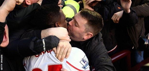 Divock Origi gets a kiss from a Liverpool fan after scoring for Liverpool