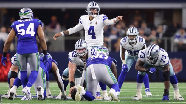Cowboys quarterback Dak Prescott (4) gestures at the line of scrimmage during the first half against the Seattle Seahawks
