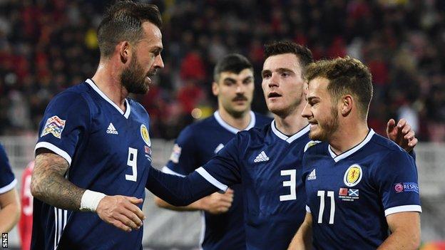 Steven Fletcher celebrates a Scotland goal with Andy Robertson and Ryan Fraser